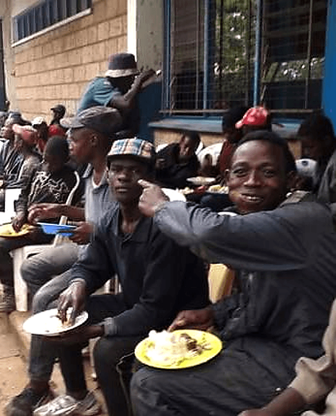 Rhema Compassion feeding program serving hot food at a community outreach